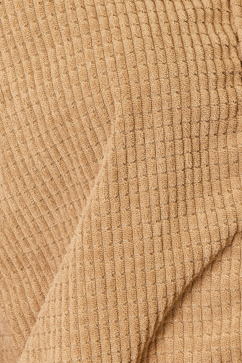 Close-up of beige ribbed fabric texture