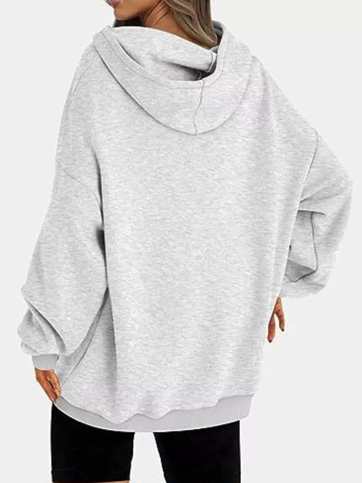 Gray oversized hoodie worn by a person on a white background