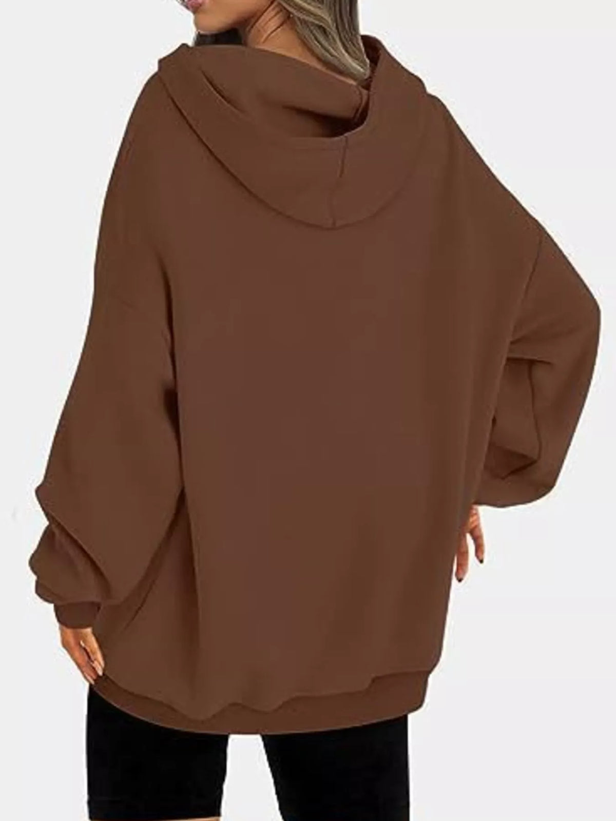 Brown oversized hoodie worn by a person on a white background