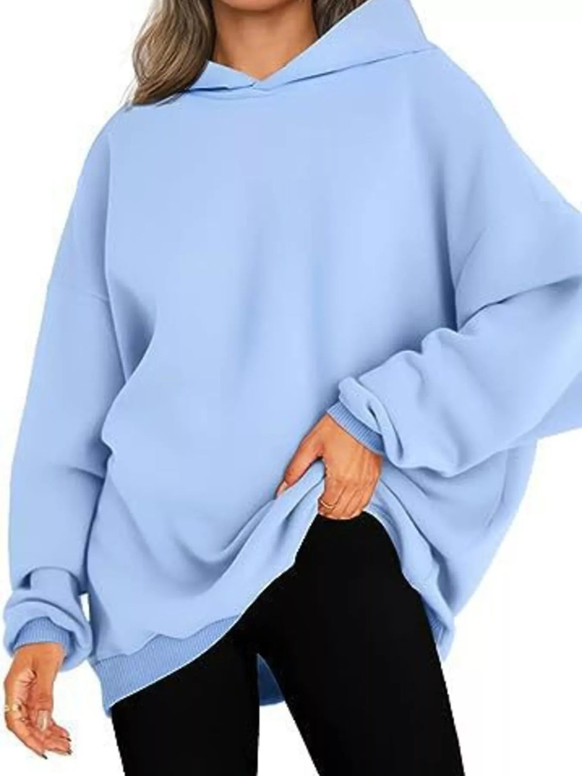 Light blue oversized hoodie worn by a person on a white background