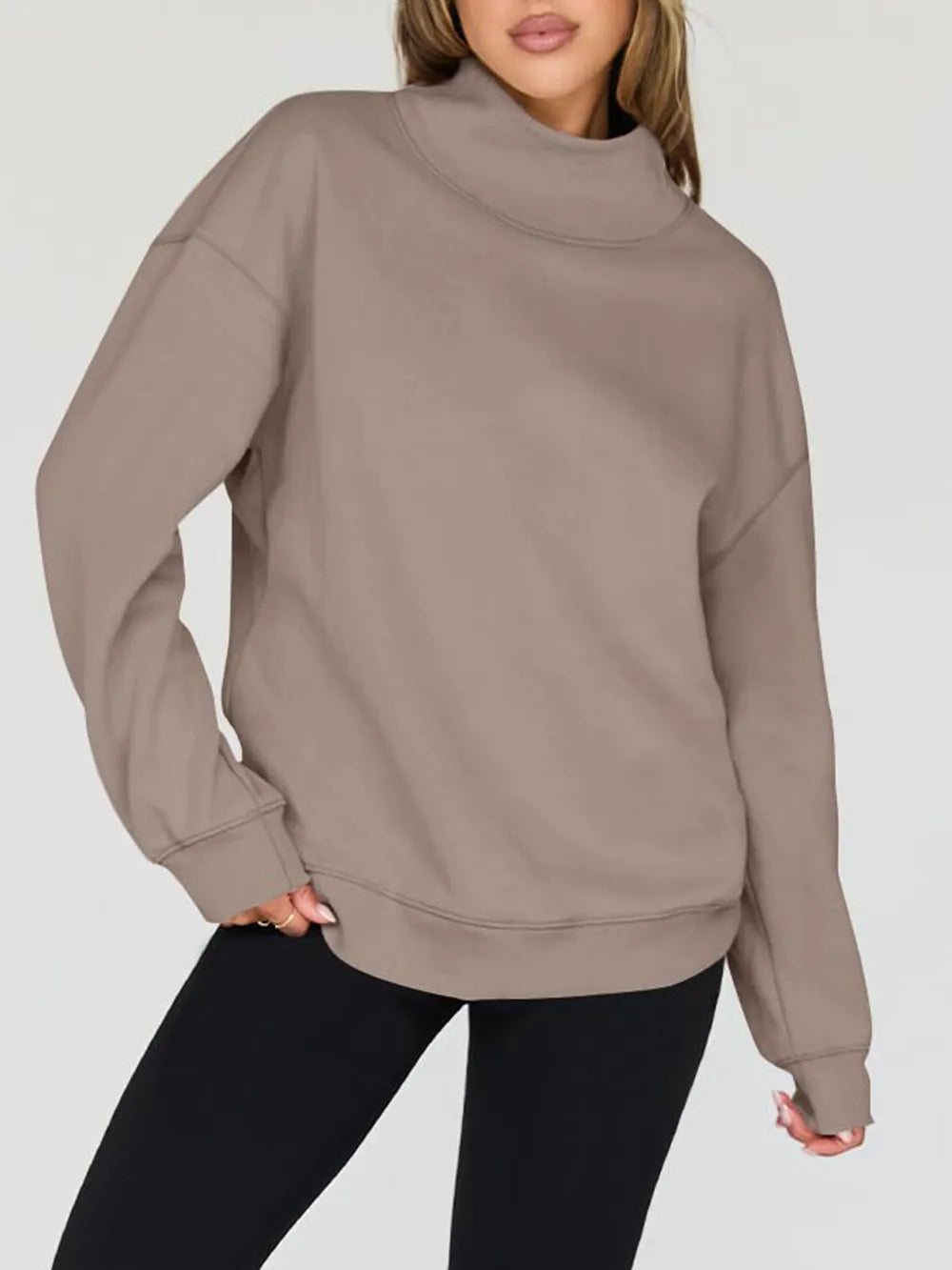 Beige sweatshirt worn by a person on a white background