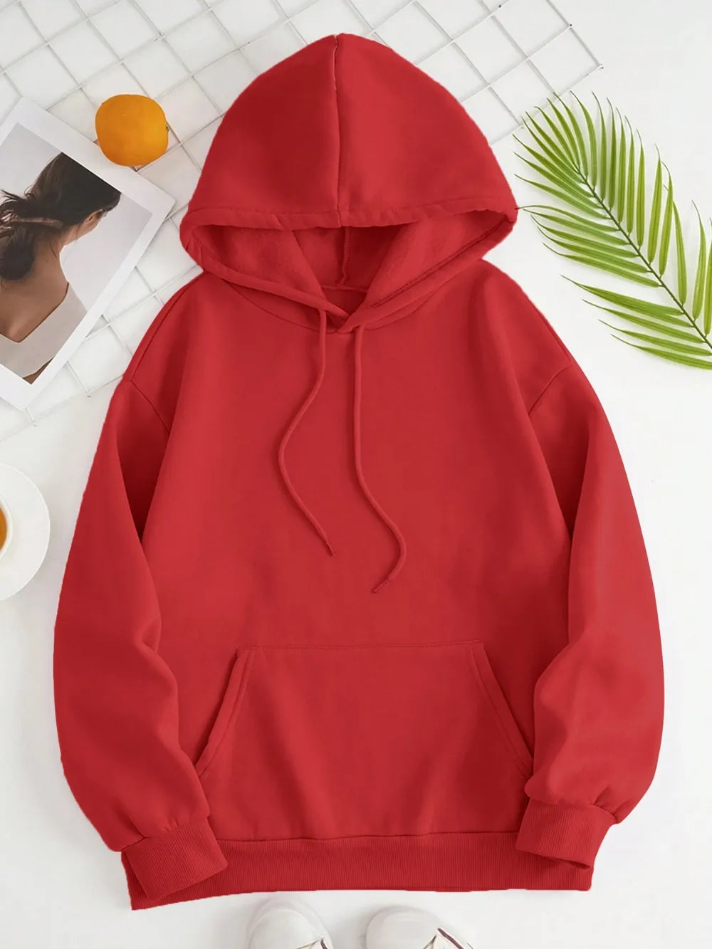 Red hoodie on a white background with a leaf decoration