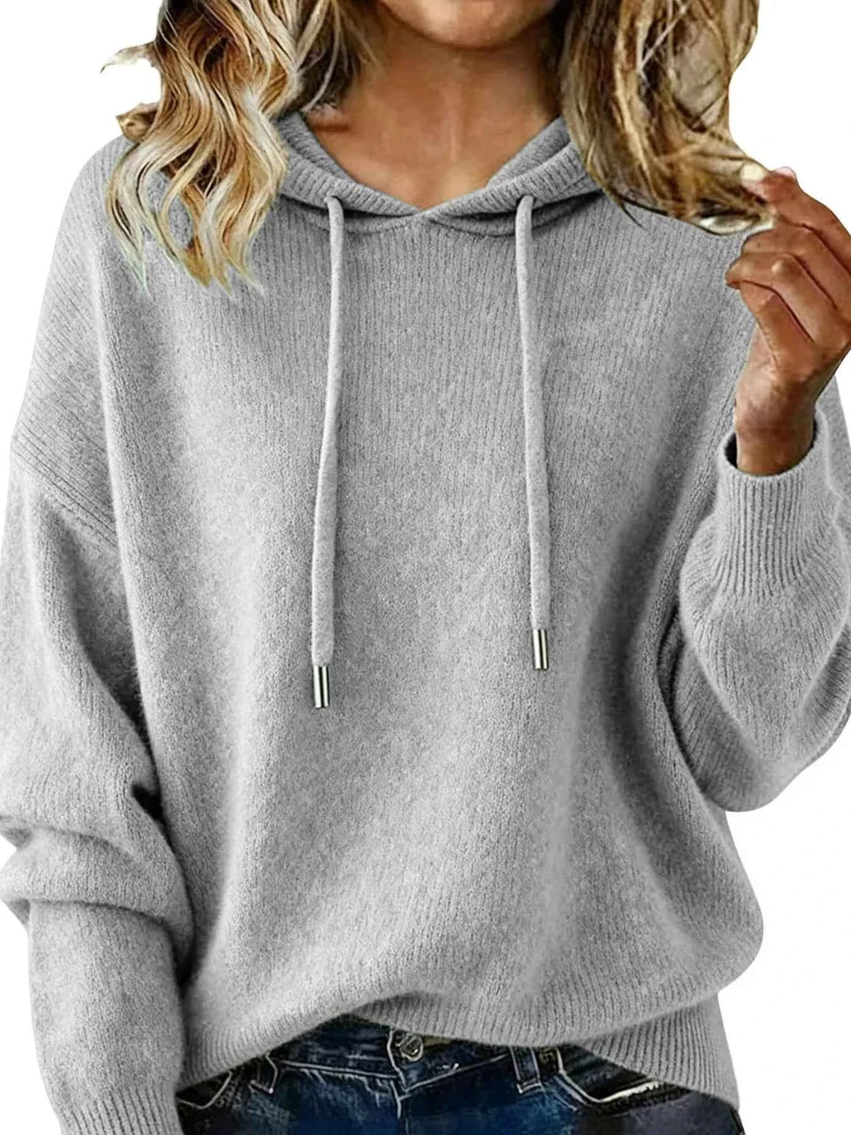 Gray hoodie worn by a person on a white background