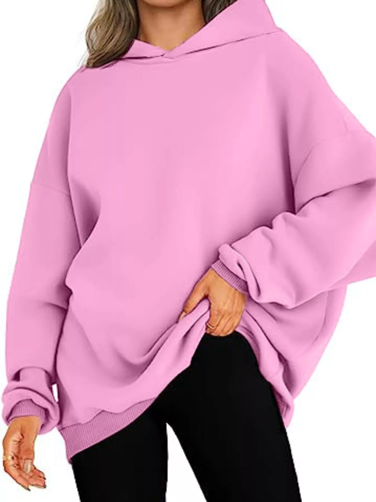 Pink hoodie worn by a person on a white background