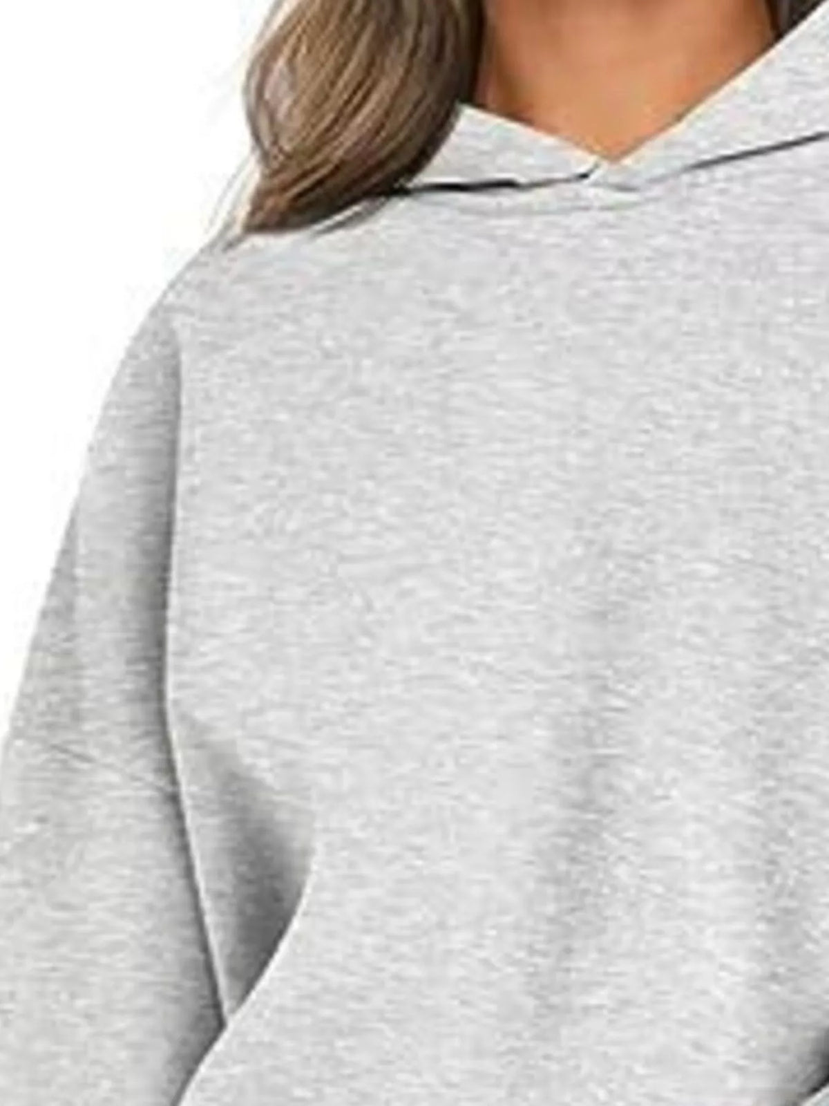 Gray oversized hoodie worn by a person on a white background