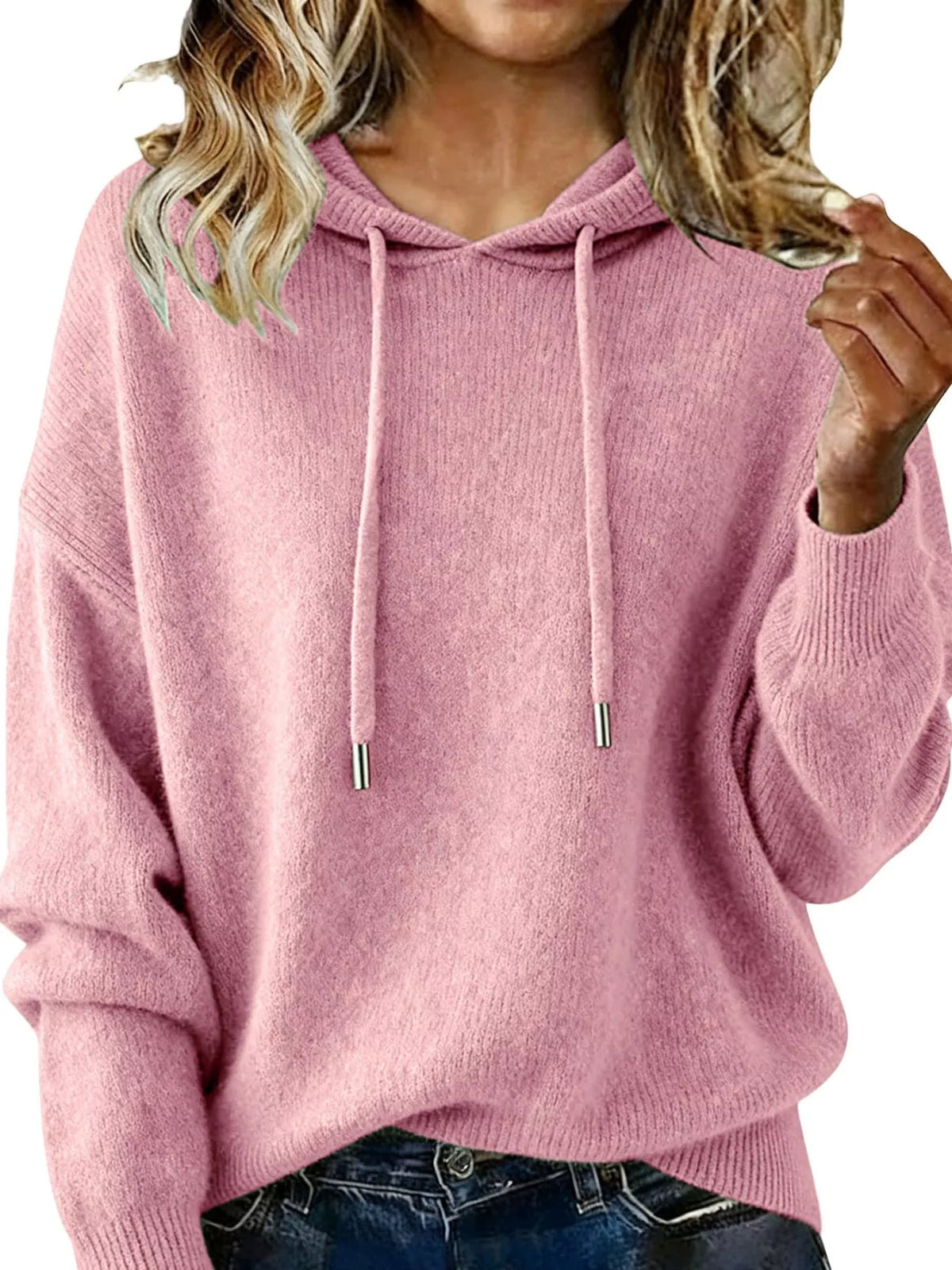 Pink hoodie worn by a person on a white background
