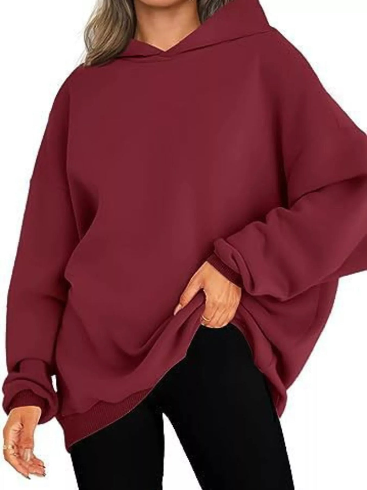 Maroon hoodie worn by a person on a white background