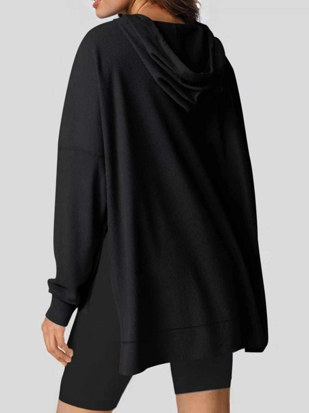 Beige hoodie worn by a person on a plain background