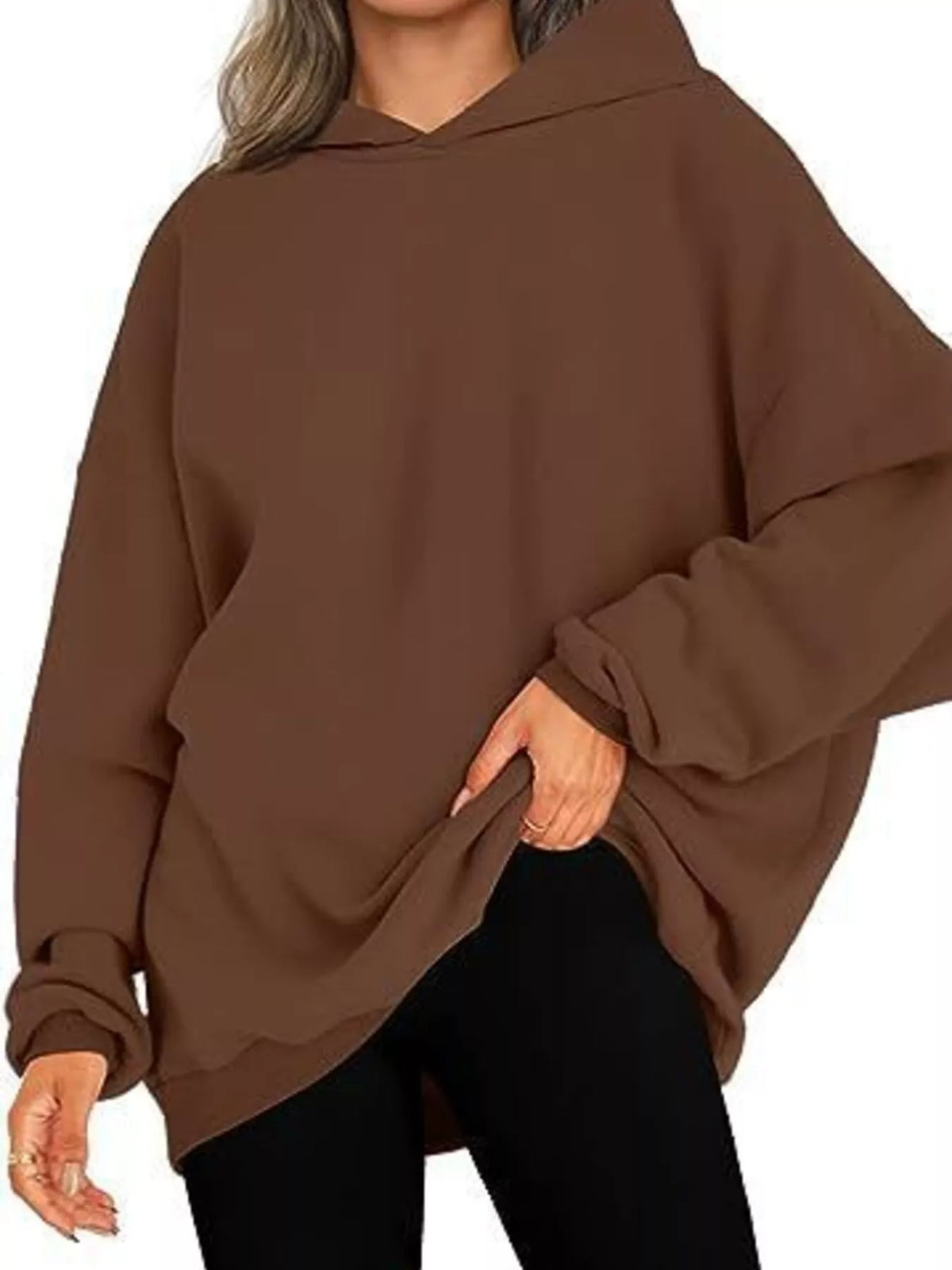 Brown oversized hoodie worn by a person on a white background