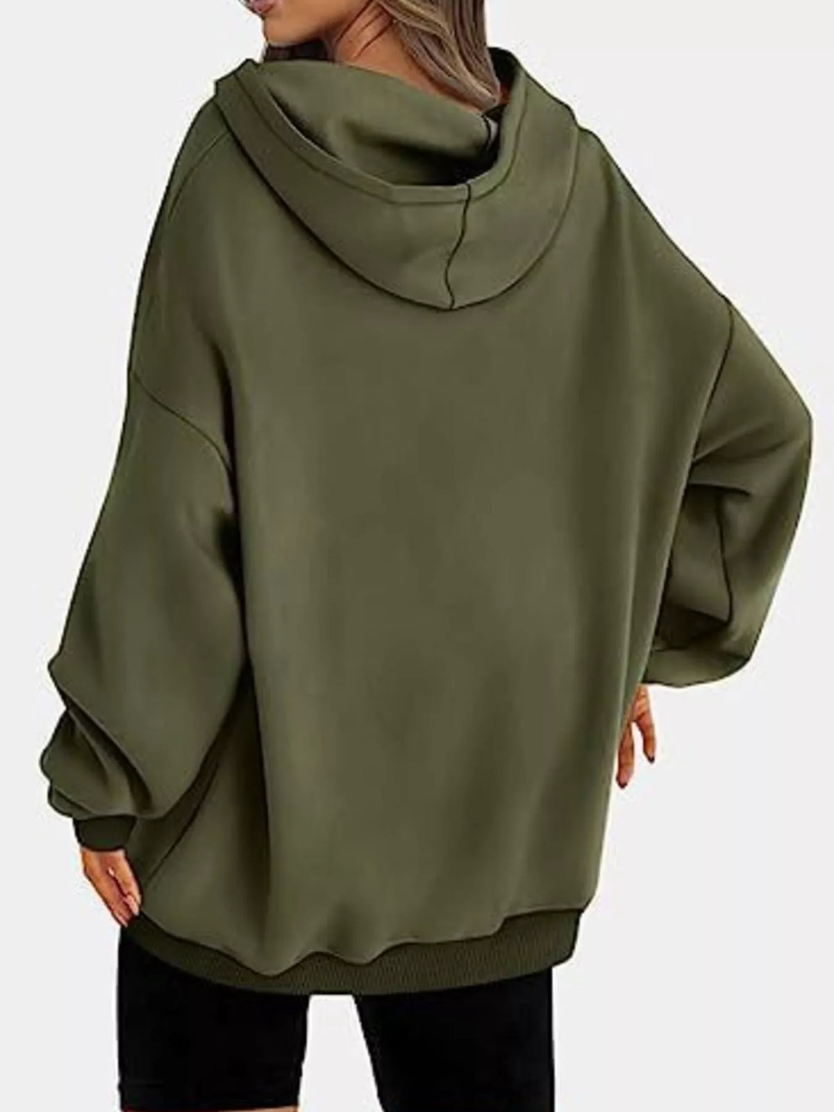 Person wearing a green hoodie on a white background