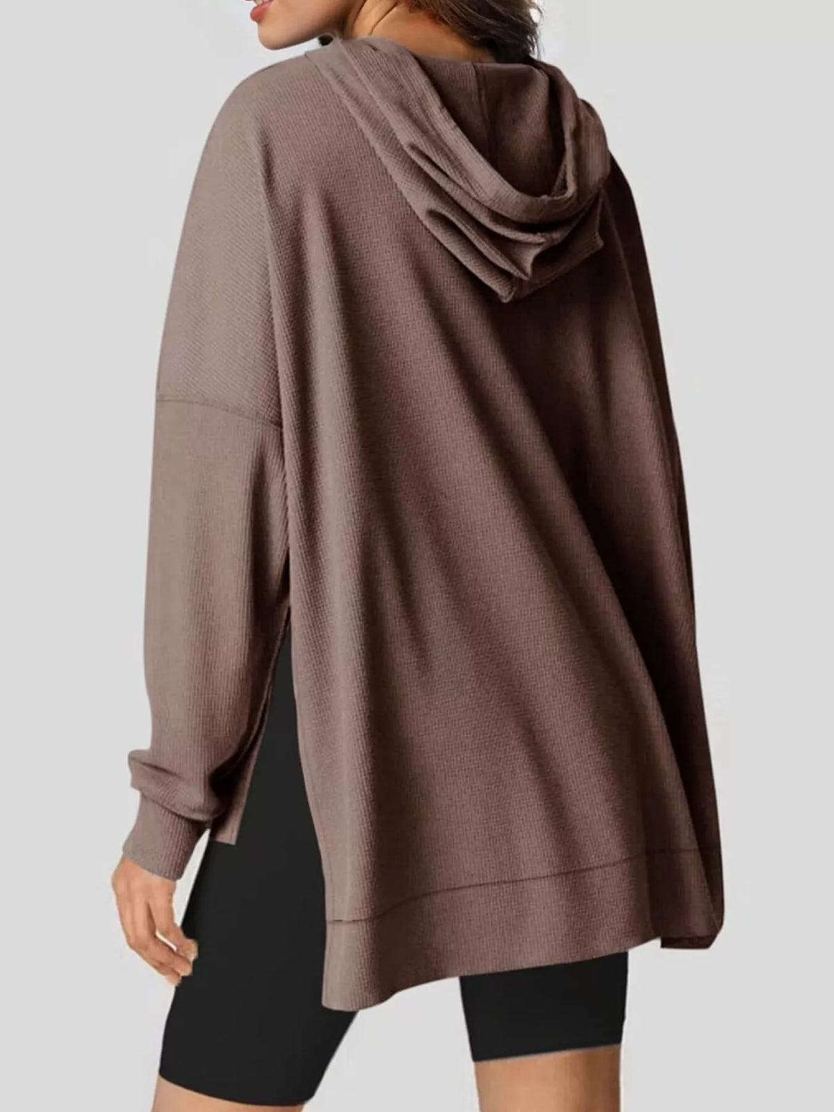 Beige hoodie worn by a person on a plain background