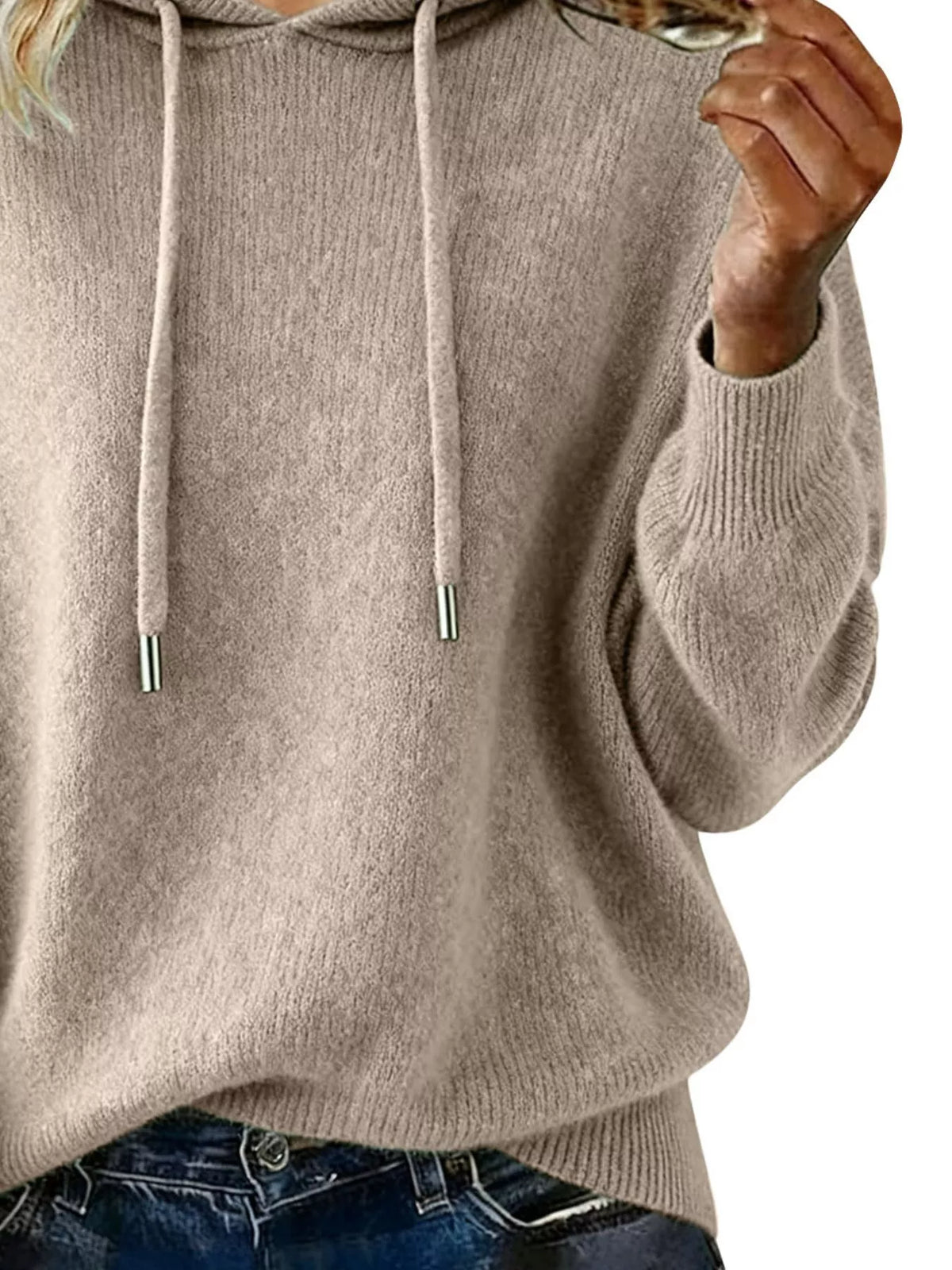 Beige hoodie worn by a person with blonde hair on a white background