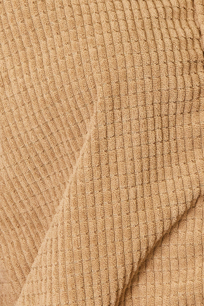 Close-up of beige ribbed fabric texture