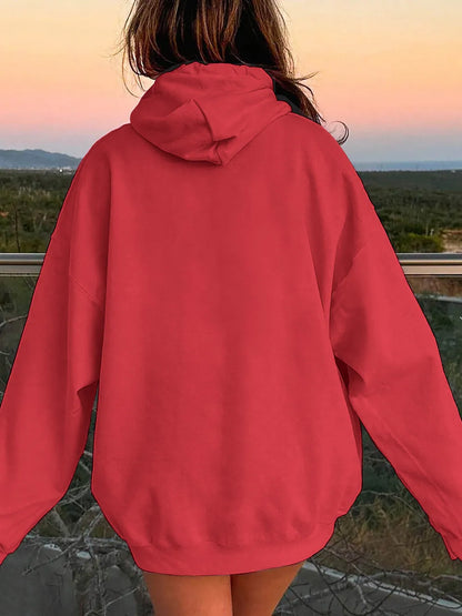 Person wearing a red hoodie with a scenic background