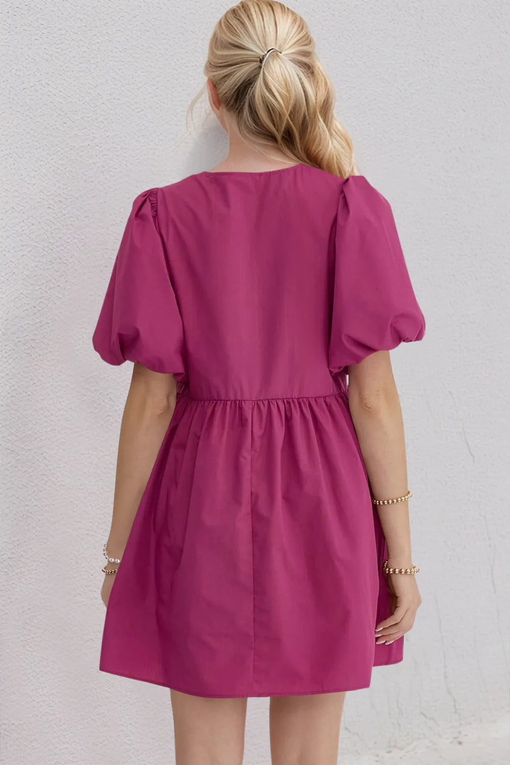 Woman wearing a pink dress against a white background