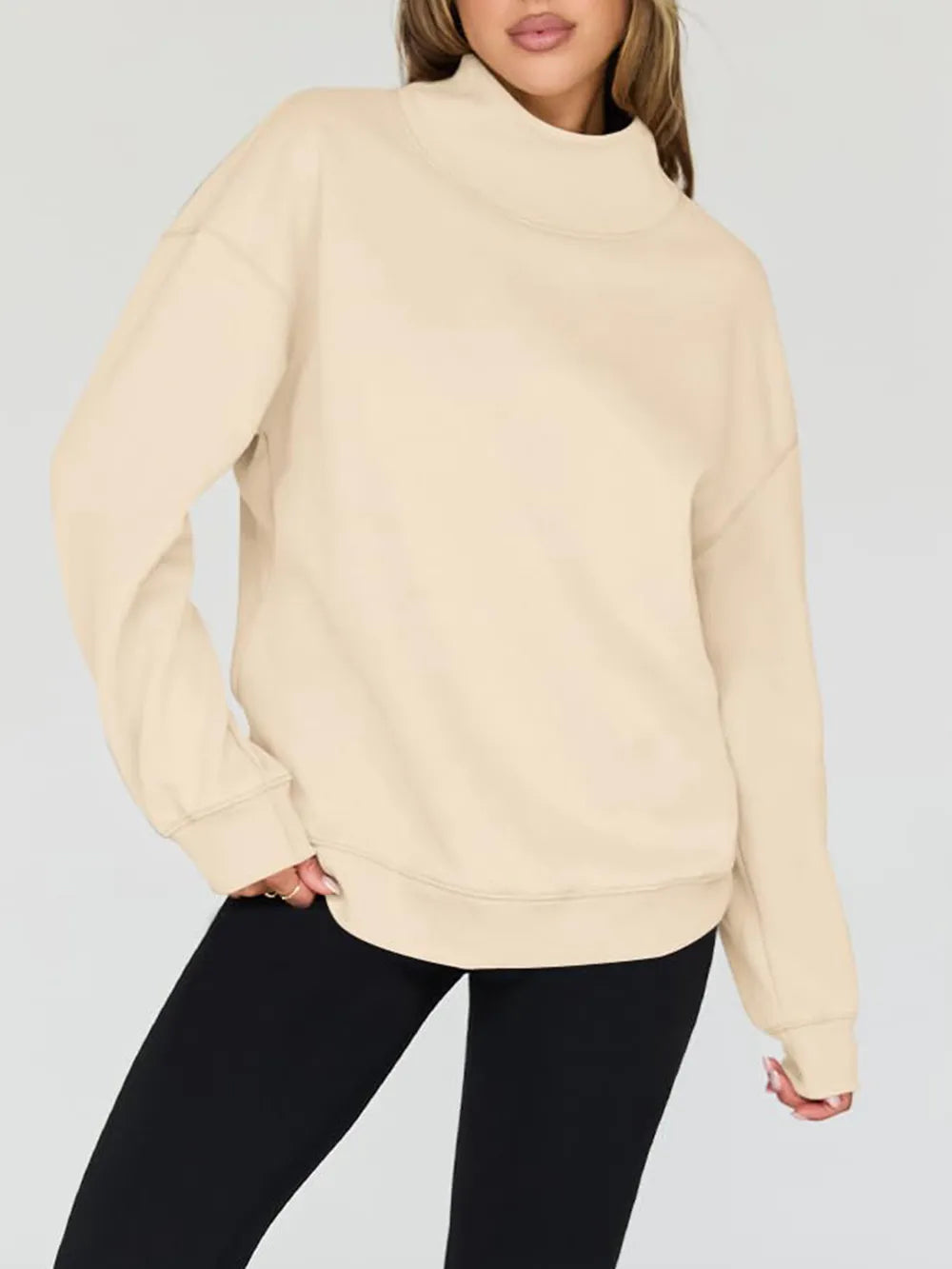 Beige sweatshirt worn by a person on a plain background