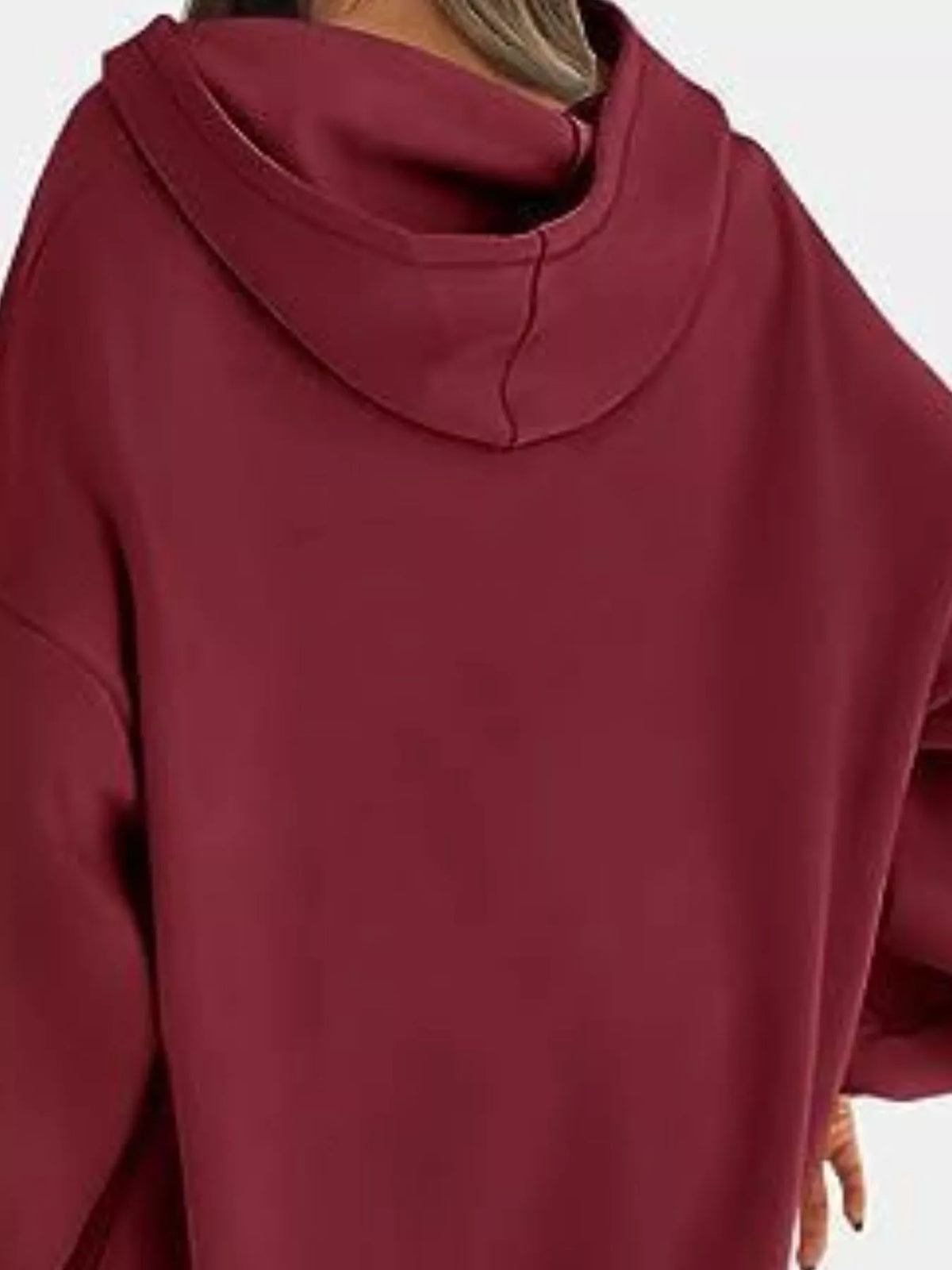 Maroon hoodie worn by a person on a white background