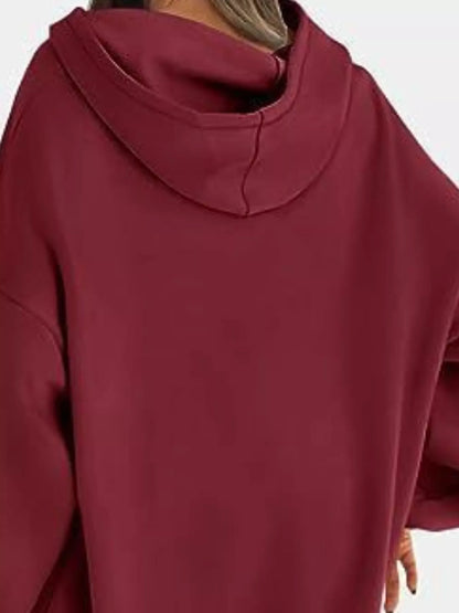 Maroon hoodie worn by a person on a white background