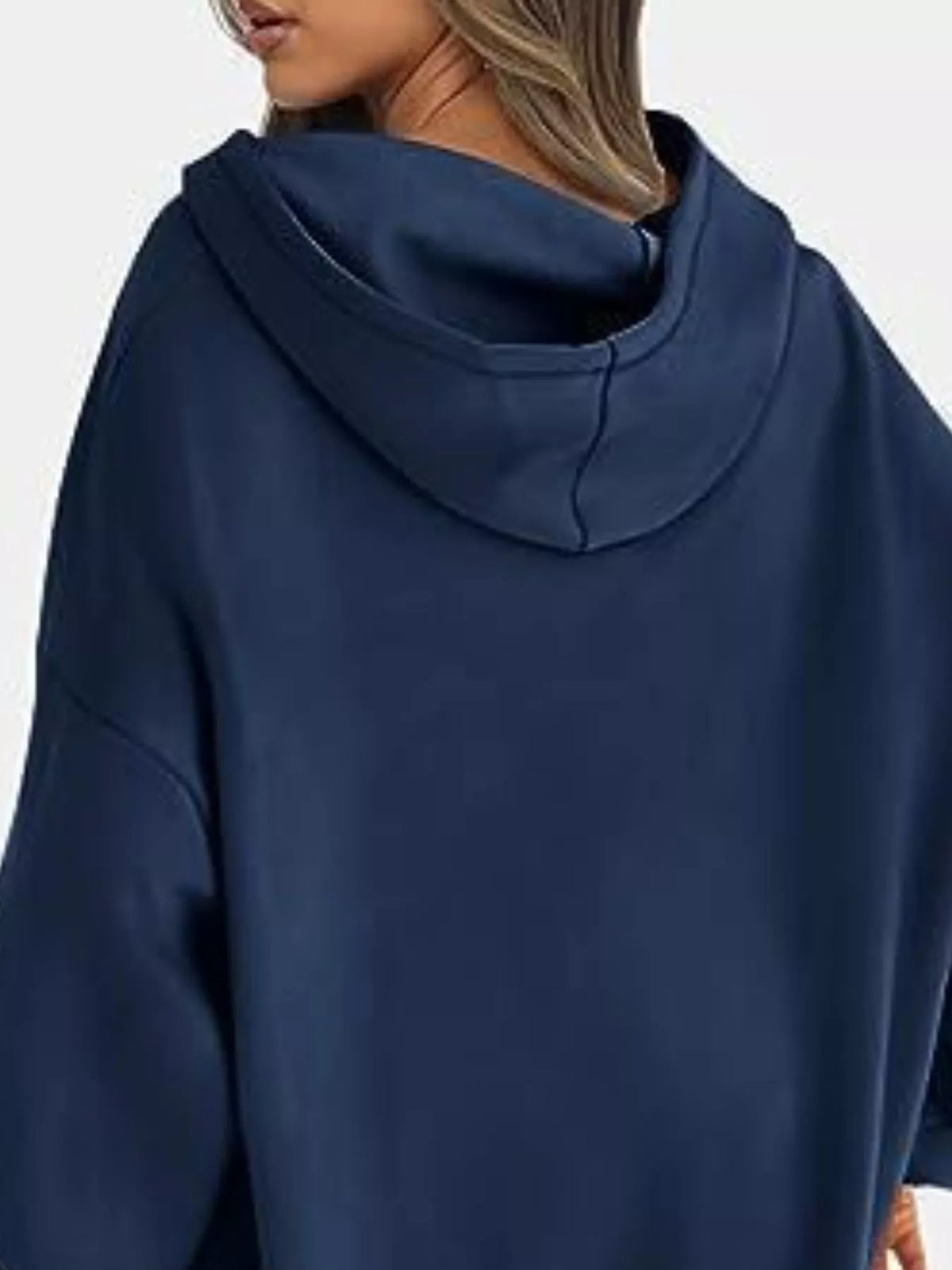 Navy blue hoodie worn by a person on a white background