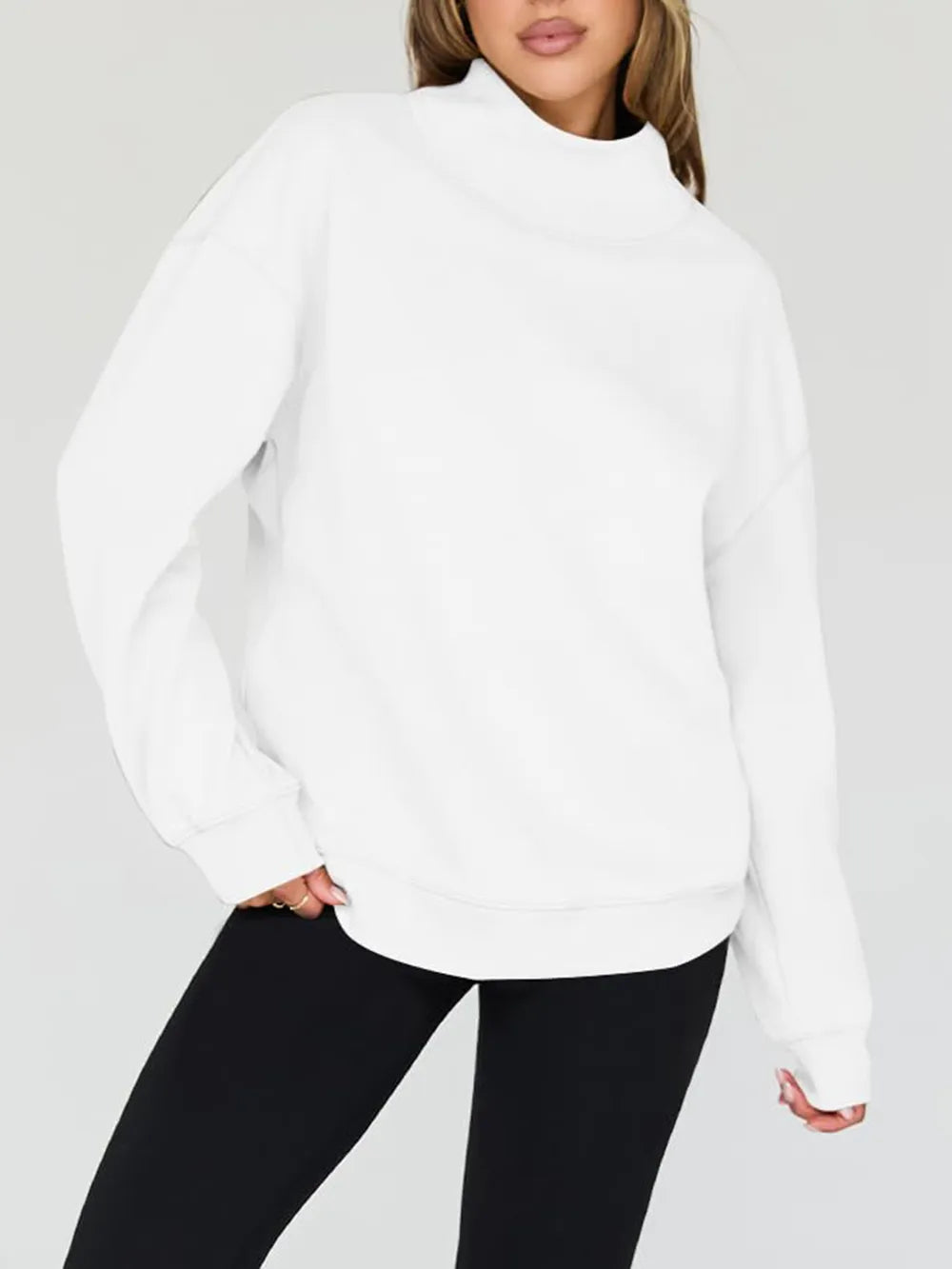 Person wearing a white sweatshirt and shorts on a plain background