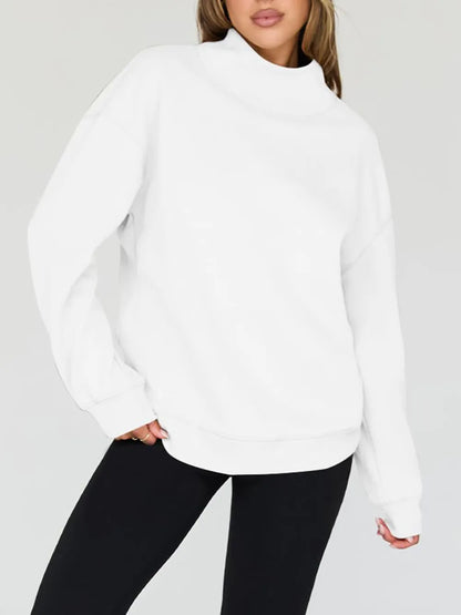 Person wearing a white sweatshirt and shorts on a plain background