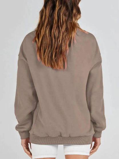 Beige sweatshirt worn by a person on a white background