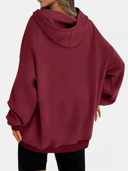 Maroon hoodie worn by a person on a white background