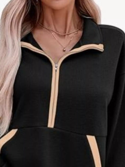 Black outfit with beige zipper details on a white background