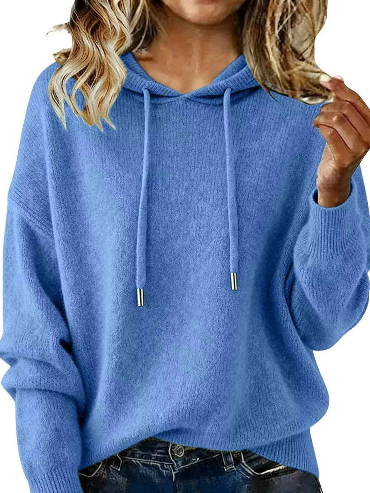 Blue hoodie worn by a person with blonde hair, close-up view.