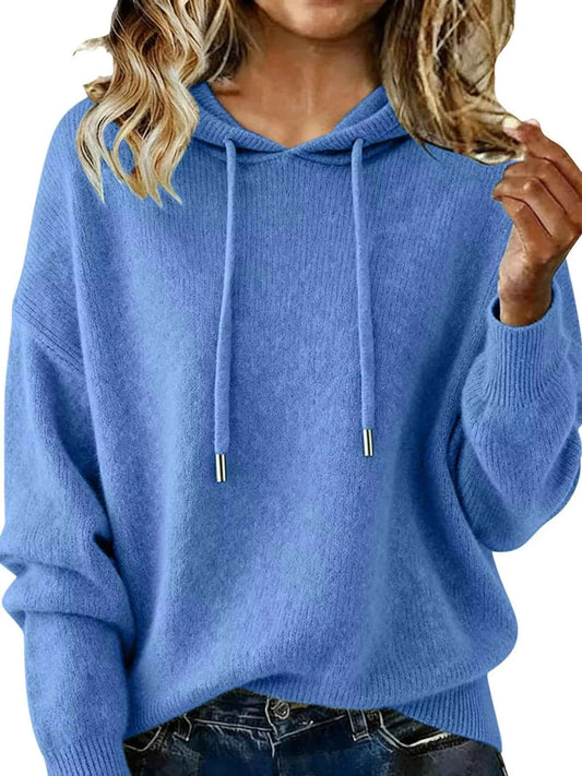 Blue hoodie worn by a person with blonde hair, close-up view.