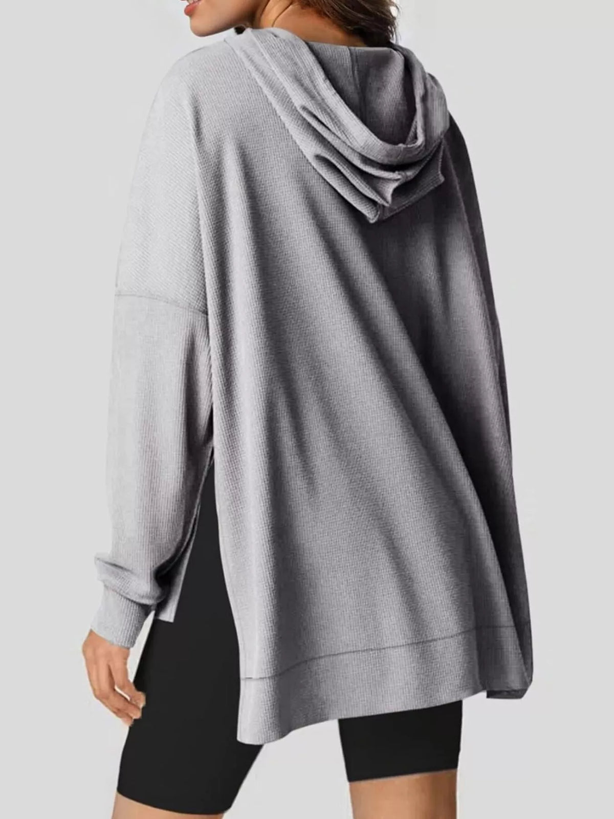 Beige hoodie worn by a person on a plain background