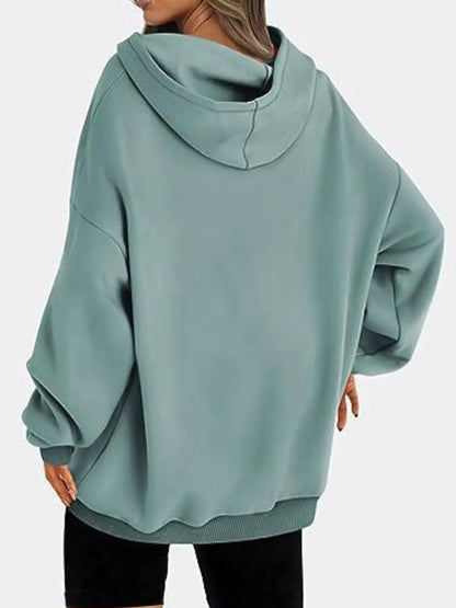 Teal hoodie worn by a person on a white background