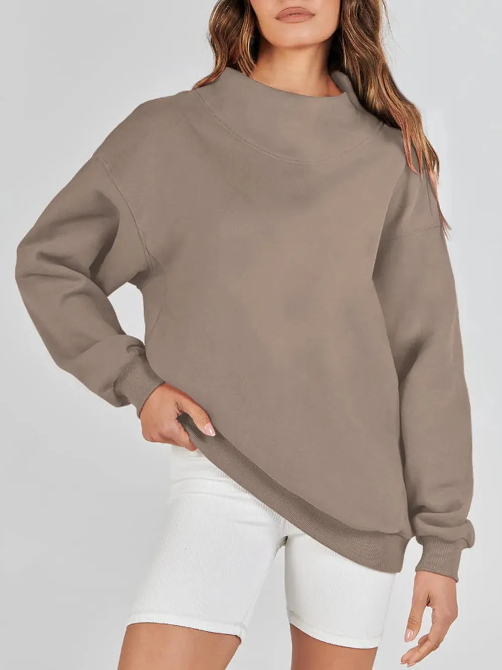 Beige sweatshirt worn by a person on a white background