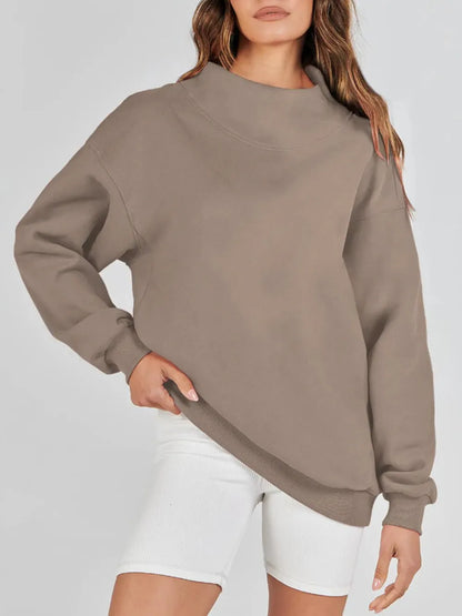 Beige sweatshirt worn by a person on a white background