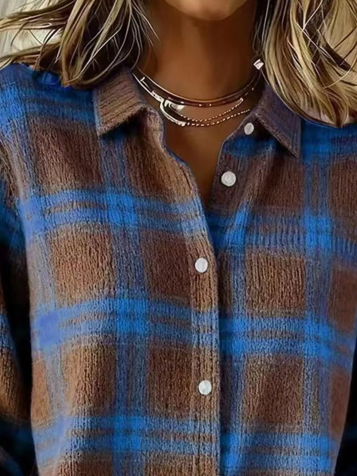 Close-up of a person wearing a brown and blue plaid button-up shirt with white buttons, layered with multiple silver necklaces.