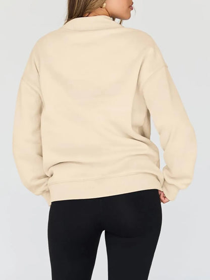 Beige sweatshirt worn by a person on a plain background