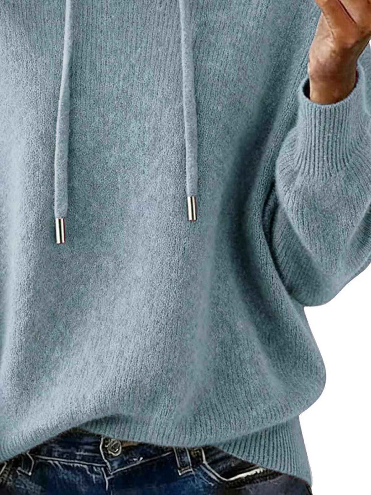 Close-up of a person wearing a light blue hoodie with a white background