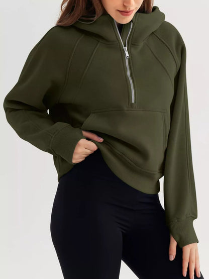 Person wearing a green hoodie with a zipper on a white background