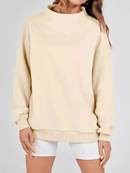 Beige sweatshirt worn by a person on a plain background