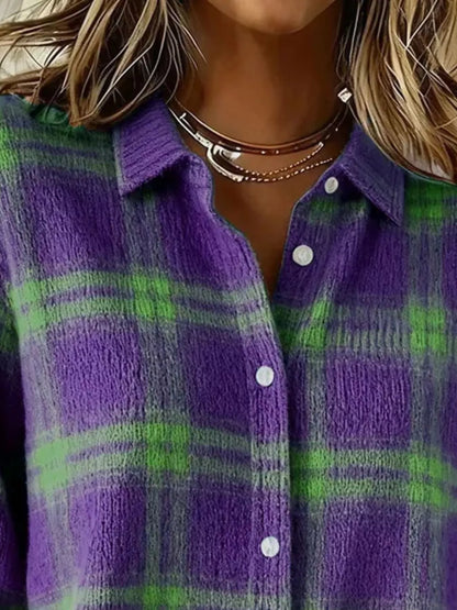 Close-up of a person wearing a fuzzy knit button-up shirt with a purple and green plaid pattern, layered with multiple silver necklaces.