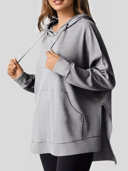 Beige hoodie worn by a person on a plain background