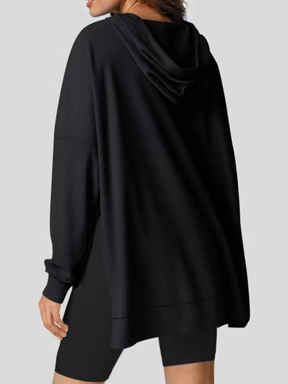 Beige hoodie worn by a person on a plain background