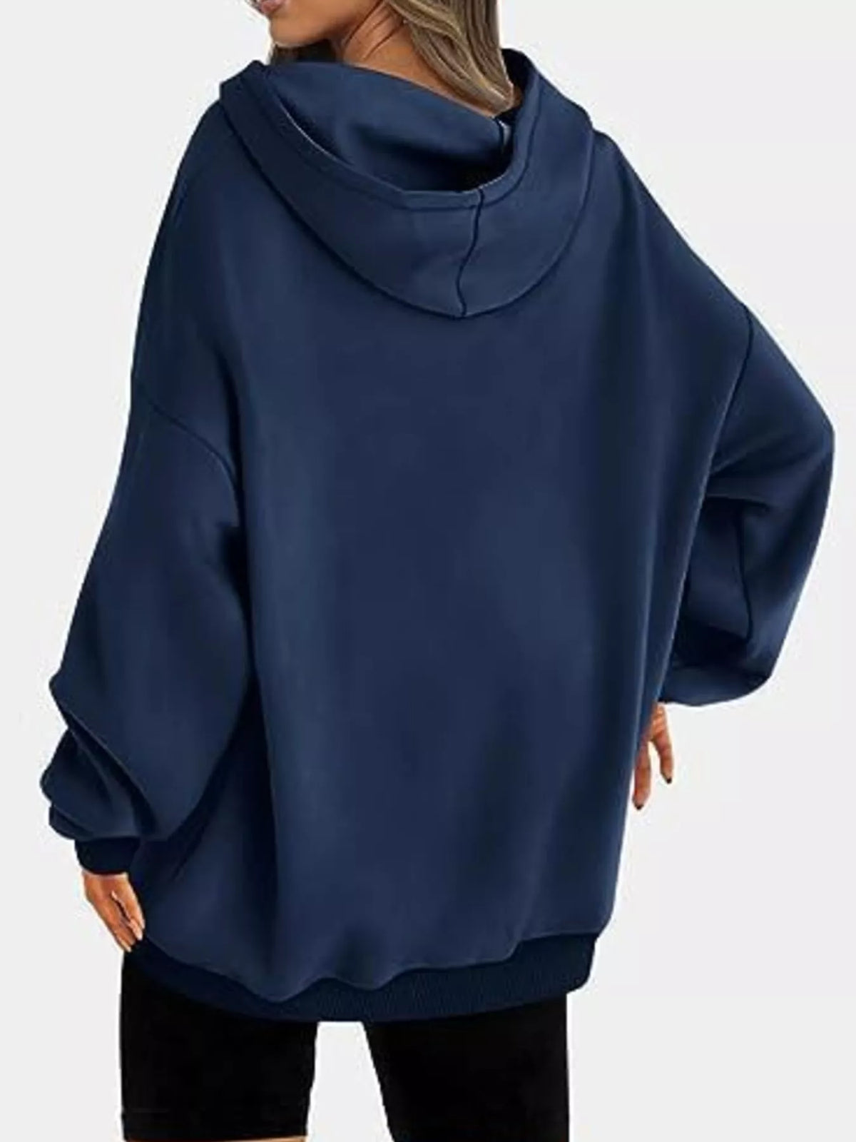 Navy blue hoodie worn by a person on a white background
