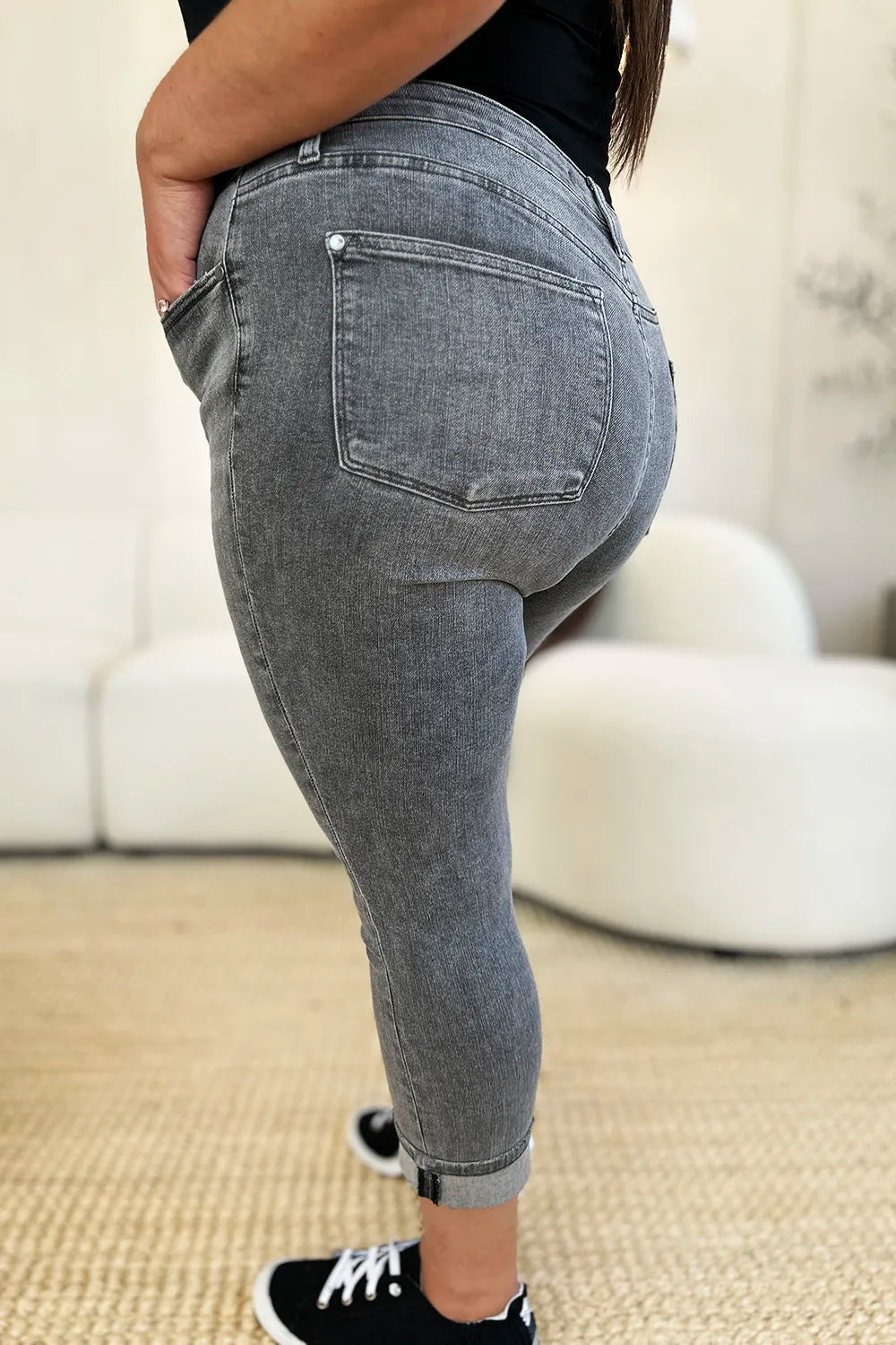 Person wearing gray jeans with a blurred background