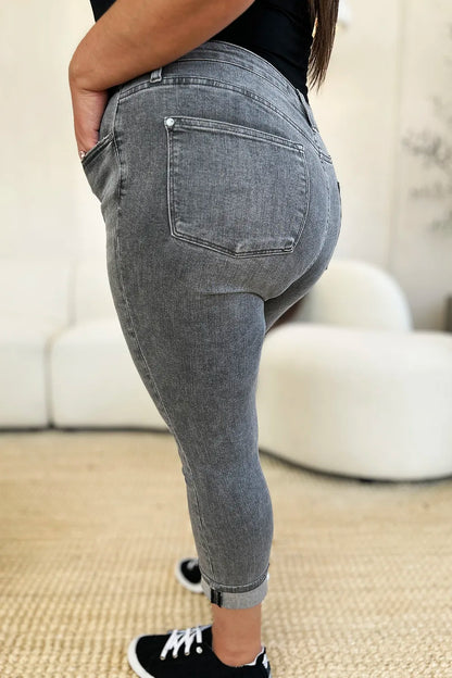 Person wearing gray jeans with a blurred background