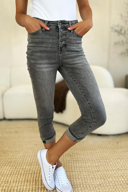 Person wearing gray jeans and white sneakers in a casual setting