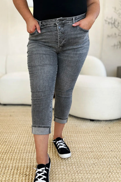 Person wearing gray jeans and black sneakers in a casual setting