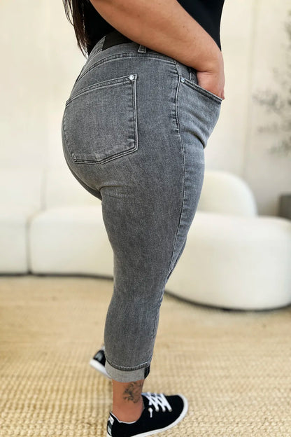 Person wearing gray jeans with a blurred background