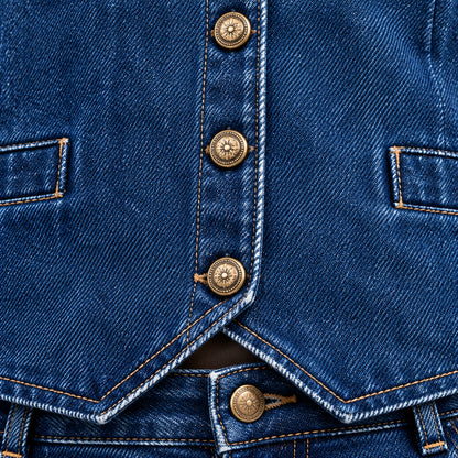  Close-up macro photograph of a fisoew two-piece denim set showing the indigo cotton fabric weave and premium vintage metal buttons for product details.