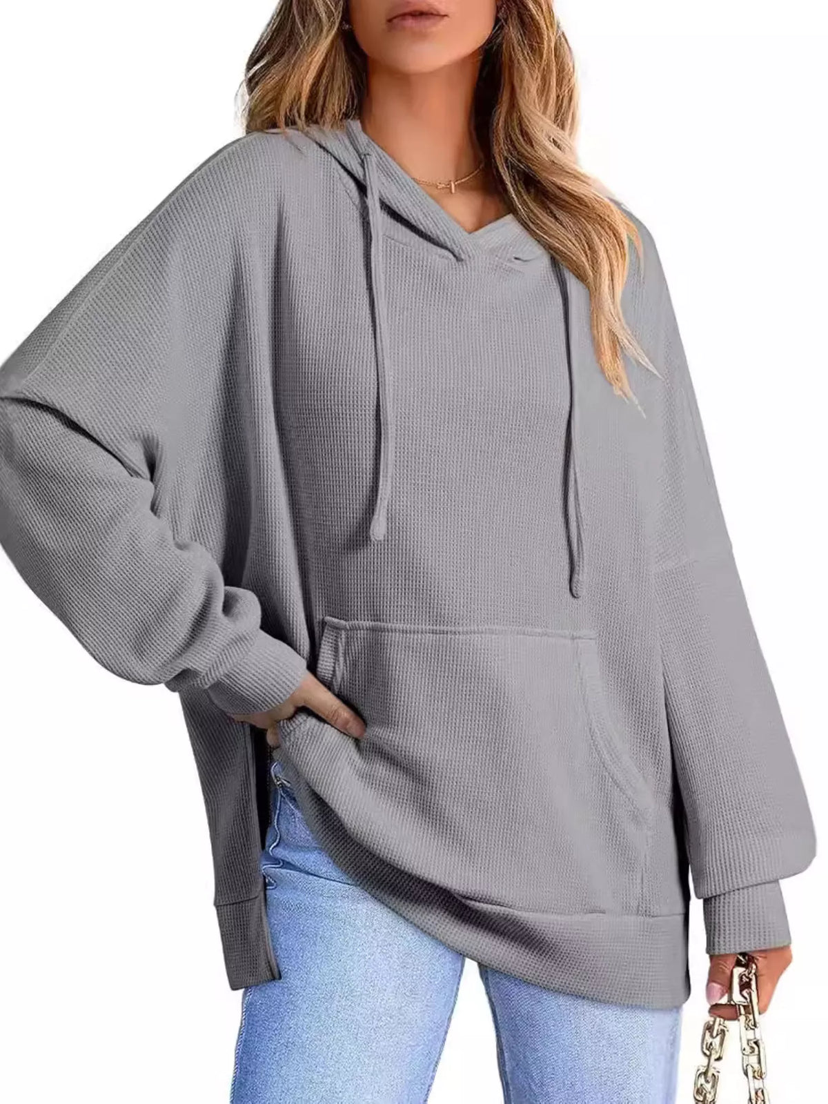 Beige hoodie worn by a person on a plain background
